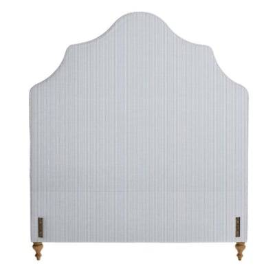 An upholstered headboard with a wooden frame that complements upholstered bed frames.
