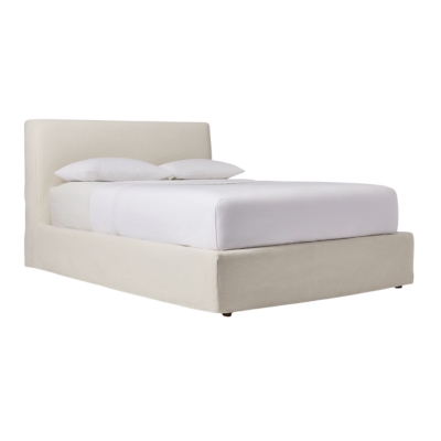 A white upholstered bed with a white headboard and footboard.