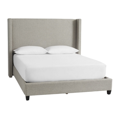 An upholstered bed with a wing-shaped headboard and footboard.