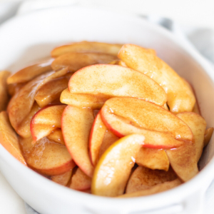 Sliced apples for apple recipes in a white bowl.