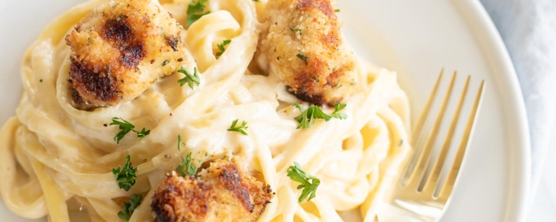 pasta on a plate with lightly breaded chicken