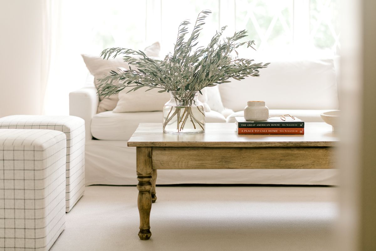 A wooden coffee table in a white living room