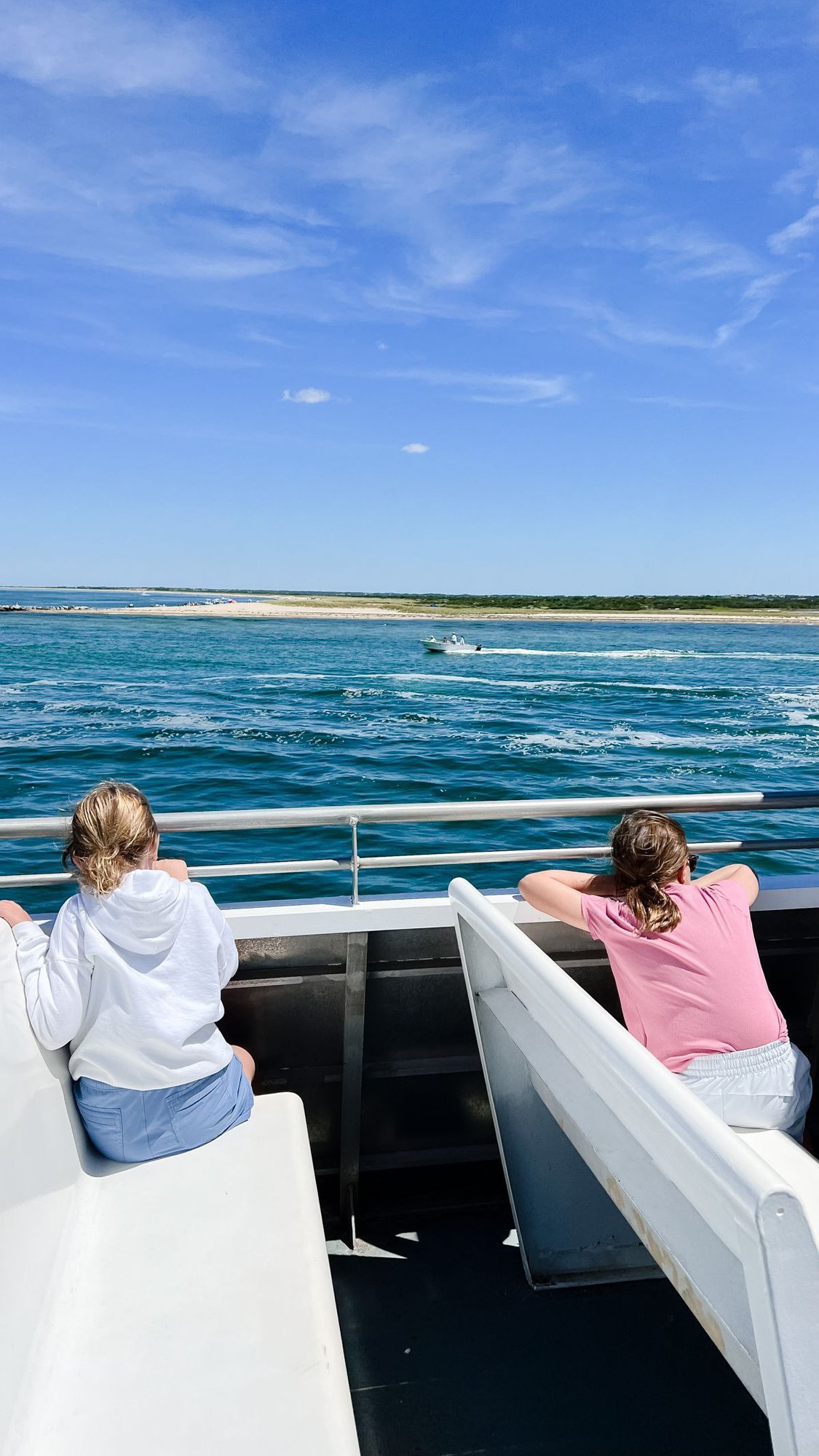 Two little girls on a boat with white bench seats, in a guide to Things to do on Nantucket island