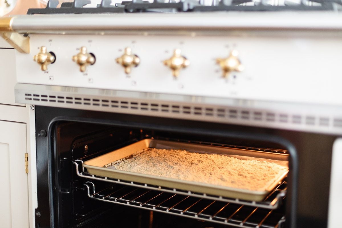 An open oven, with a view of a gold baking sheet with a substitute for panko.