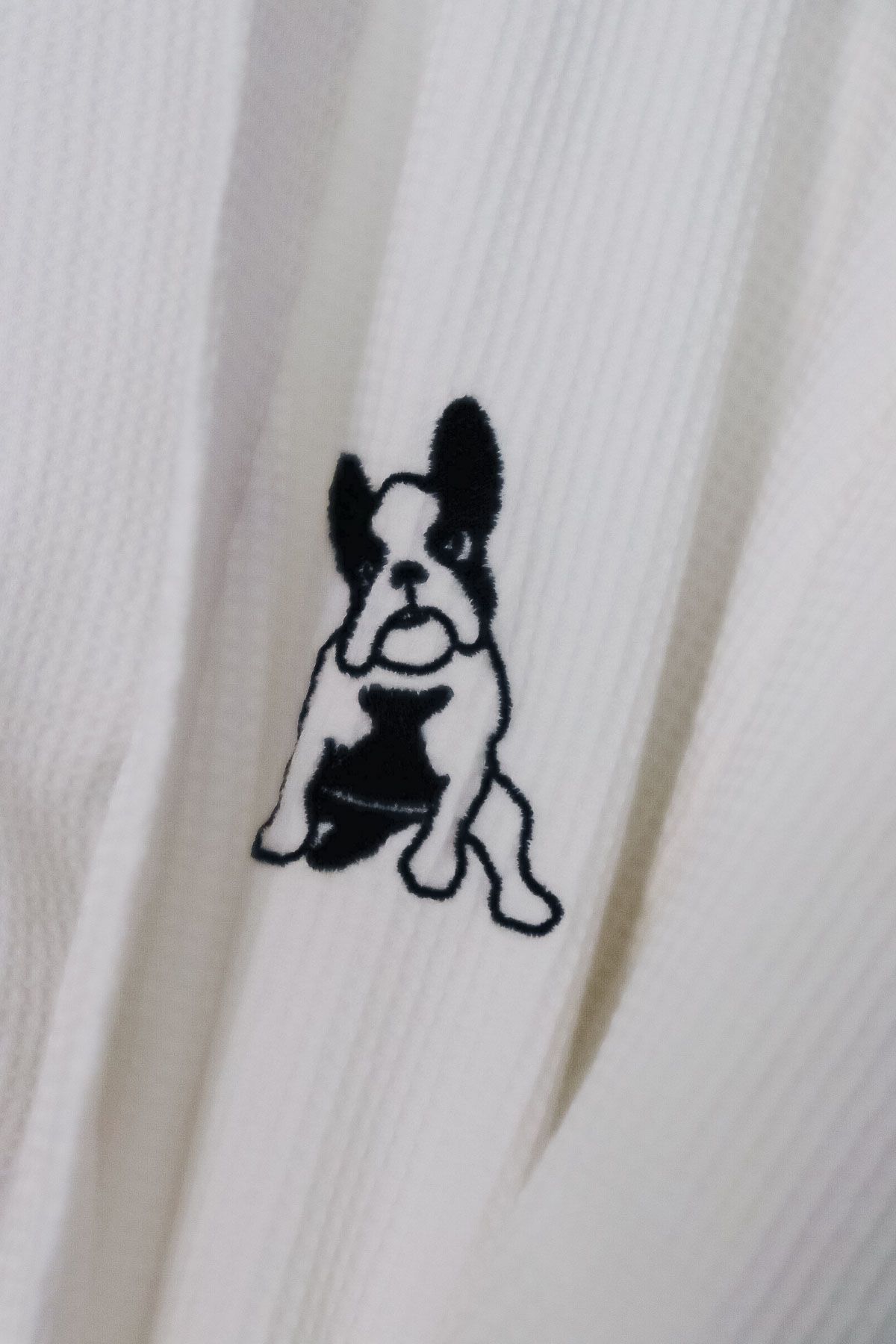 White fabric with a french bulldog embroidered on it at The Franklin Hotel in Martha's Vineyard.