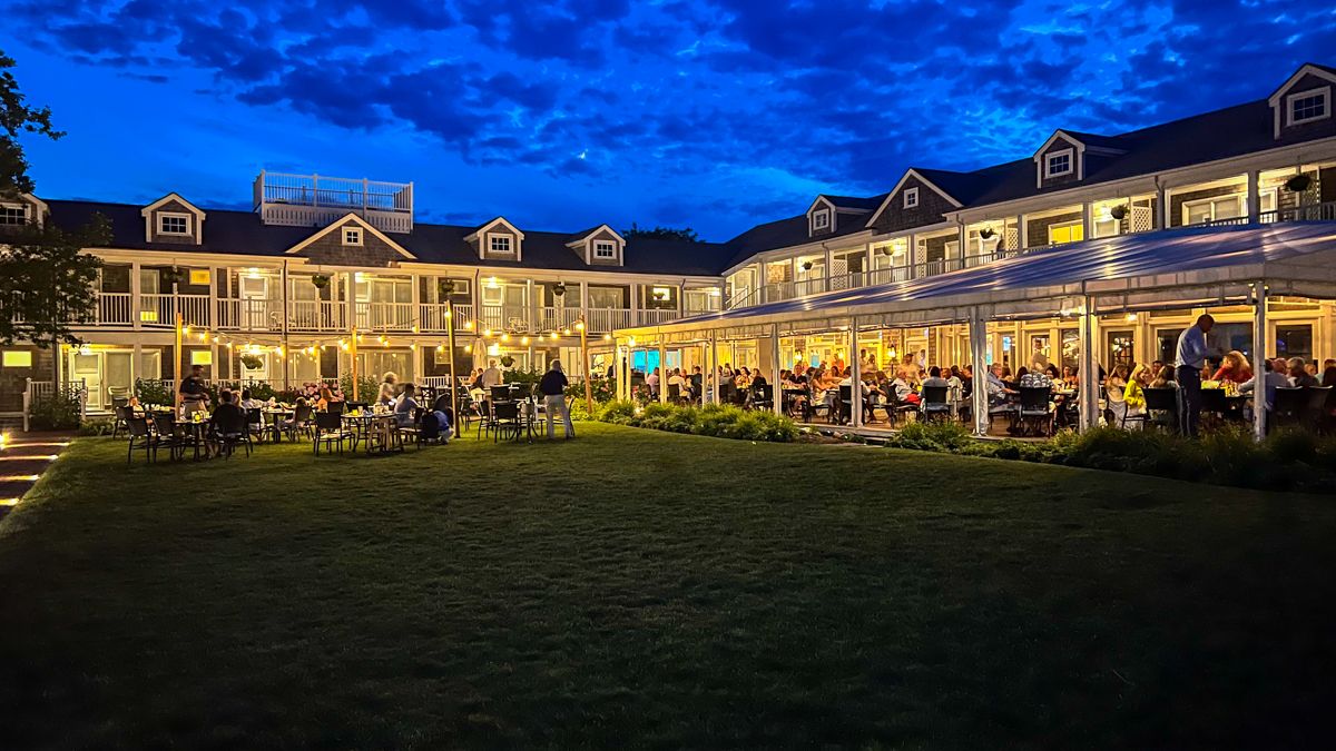 A nighttime view of a shingled restaurant on Nantucket