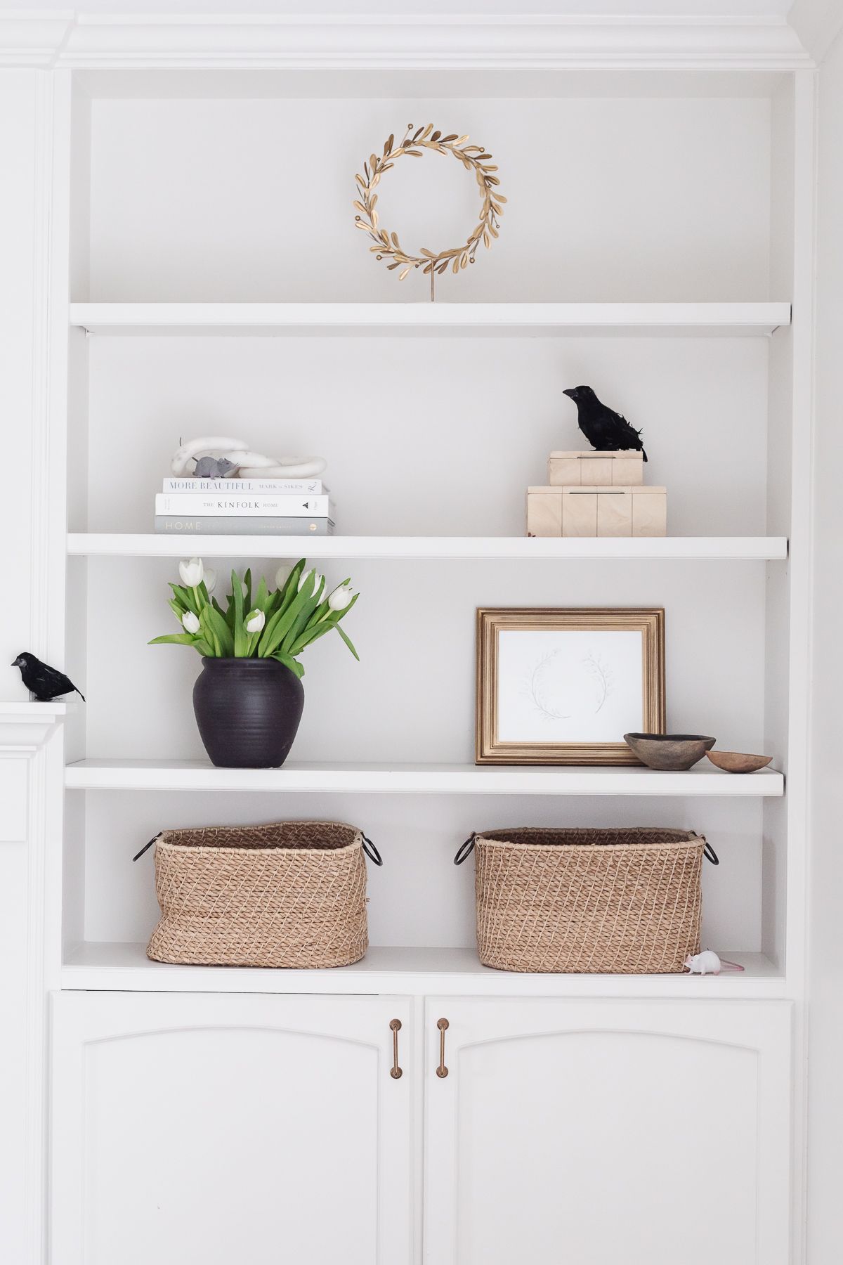 White bookshelves with hints of black crows for Halloween