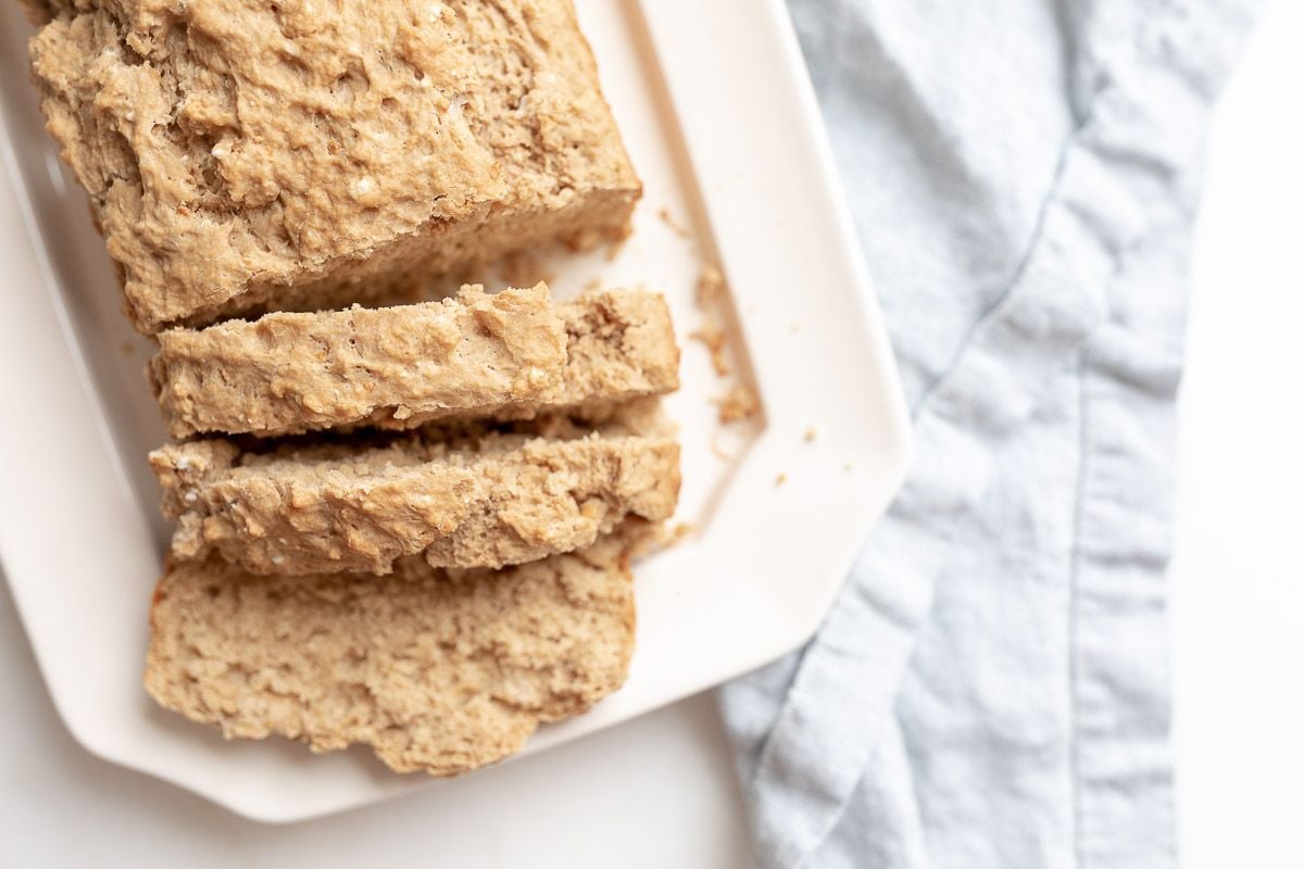 Sliced beer bread on a white platter.