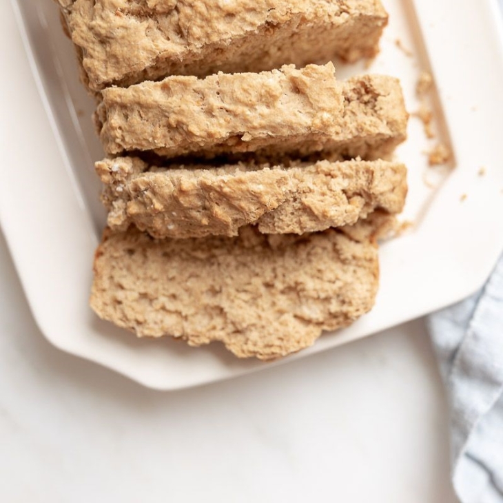 Sliced beer bread on a white platter.