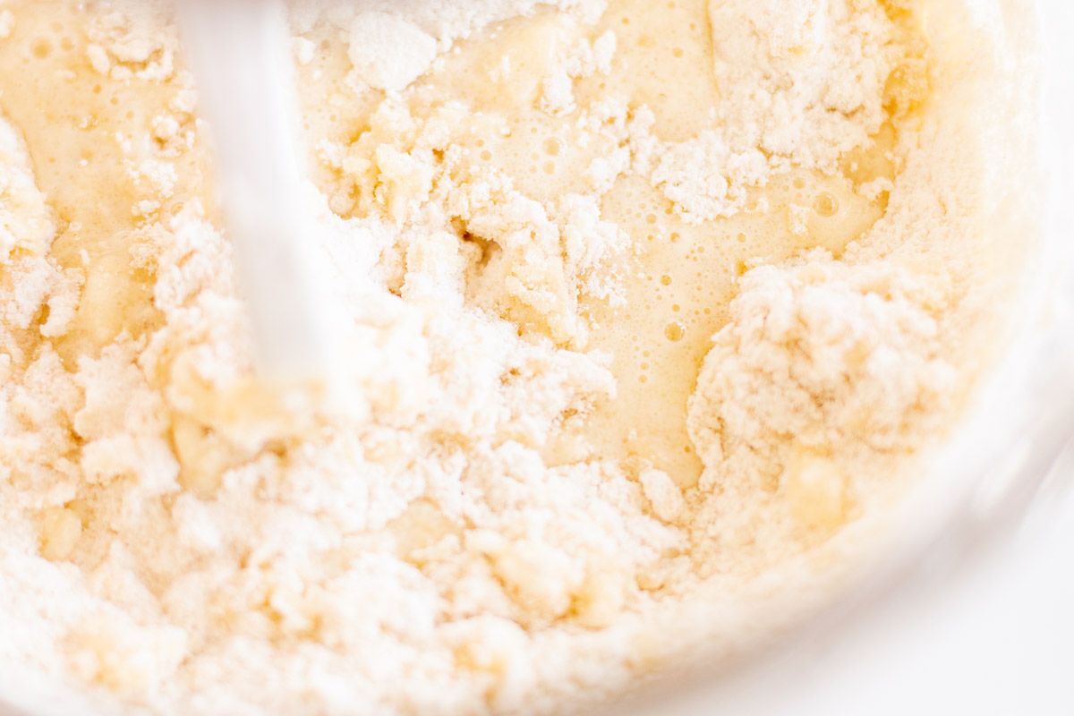 Flour and other dry ingredients inside a glass mixing bowl