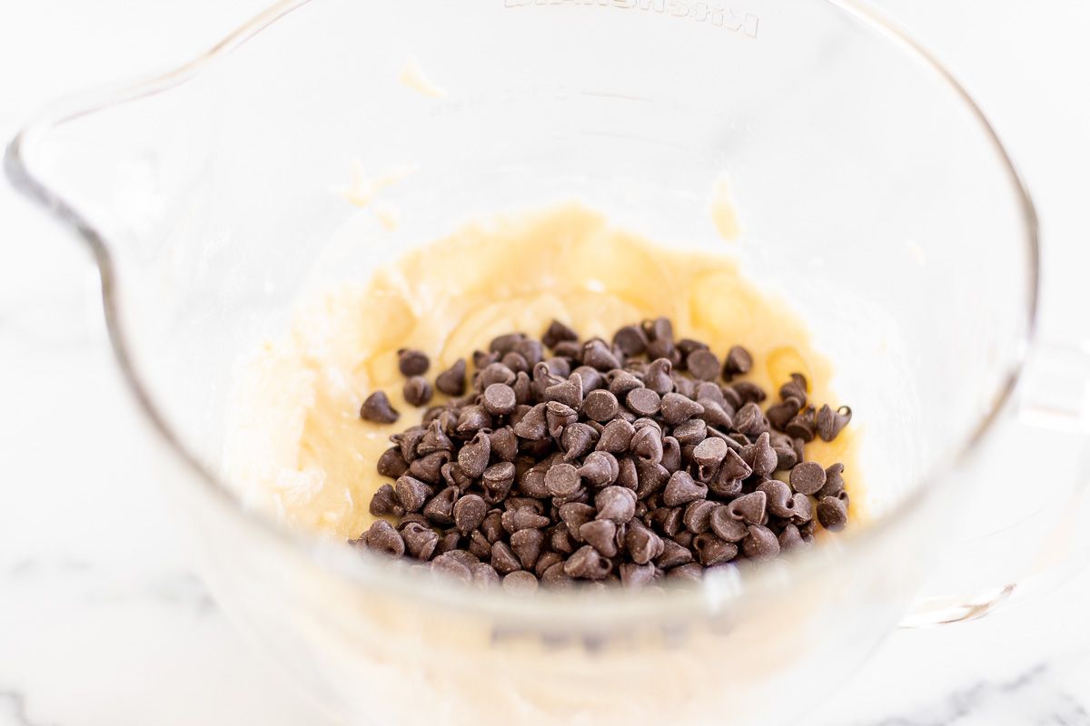 Chocolate chip bread batter in a clear glass mixing bowl