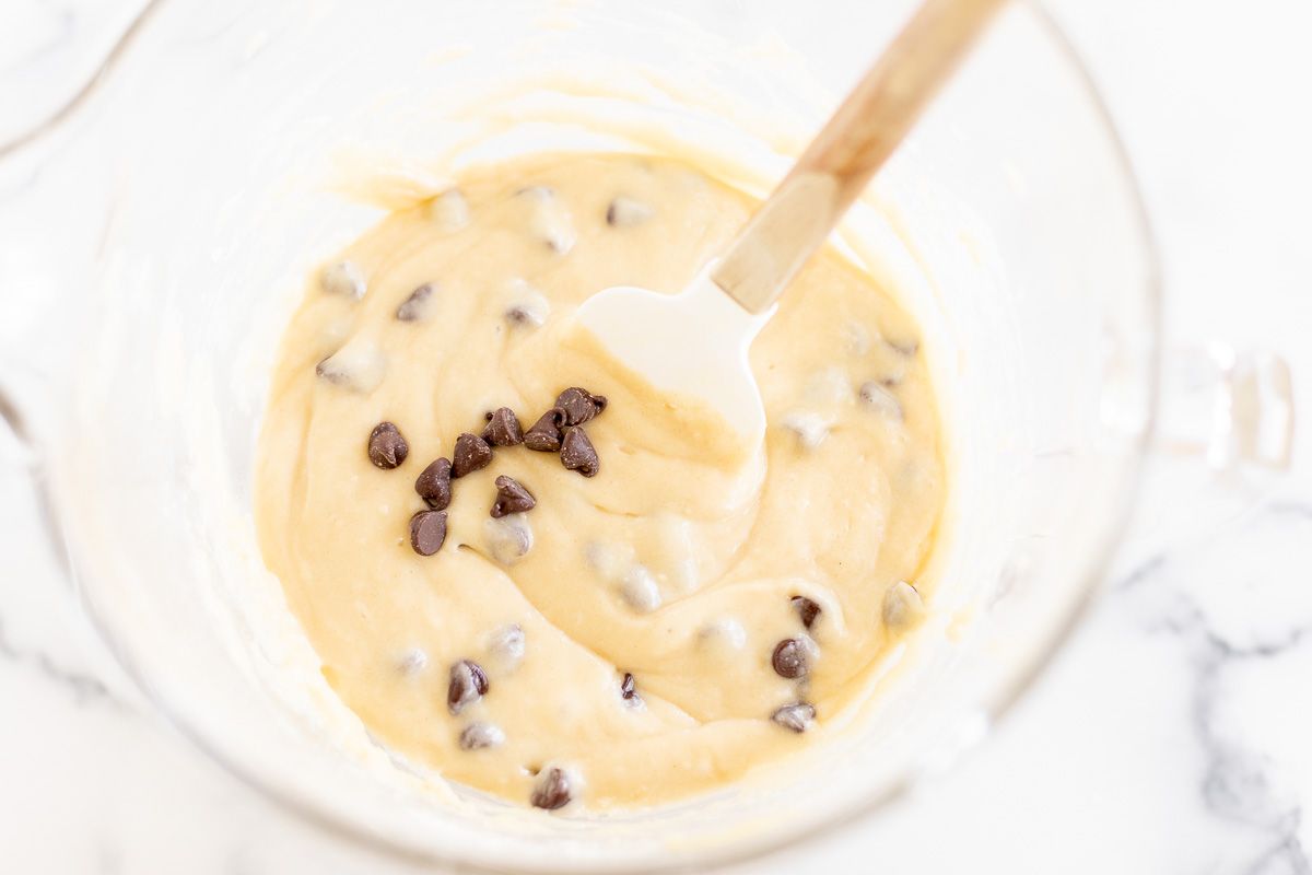 Chocolate chip bread batter in a clear glass mixing bowl