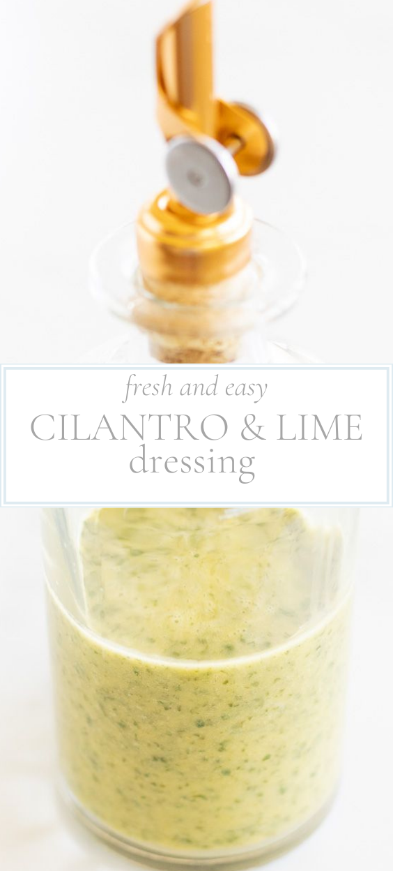 Clear glass bottle with gold pouring spout top of cilantro lime dressing.