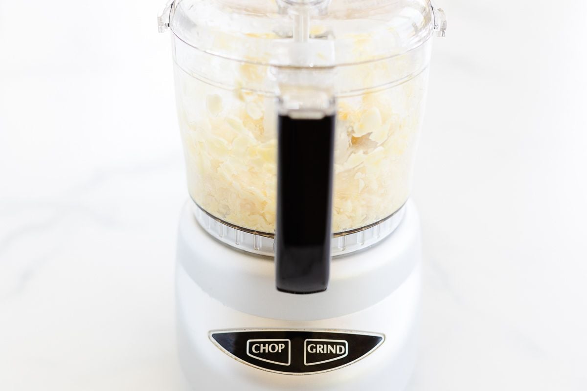 A food processor filled with homemade garlic paste