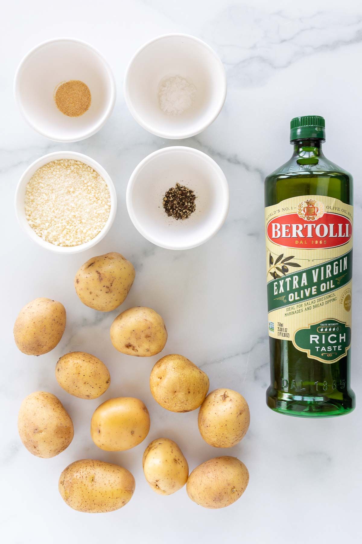 Ingredients for Parmesan potatoes laid out on a marble countertop.