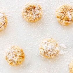 pumpkin gooey butter cookies sprinkled with powdered sugar on marble surface