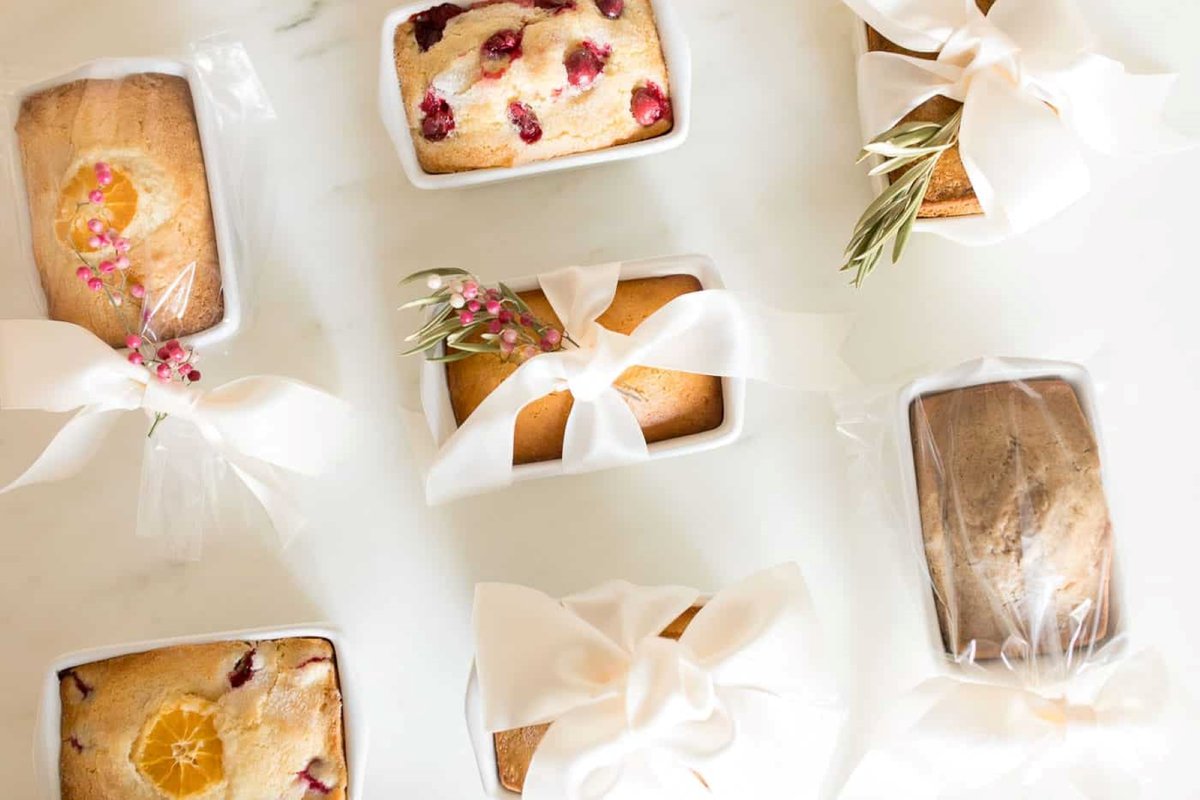 White surface with a variety of packaged mini loaves of bread