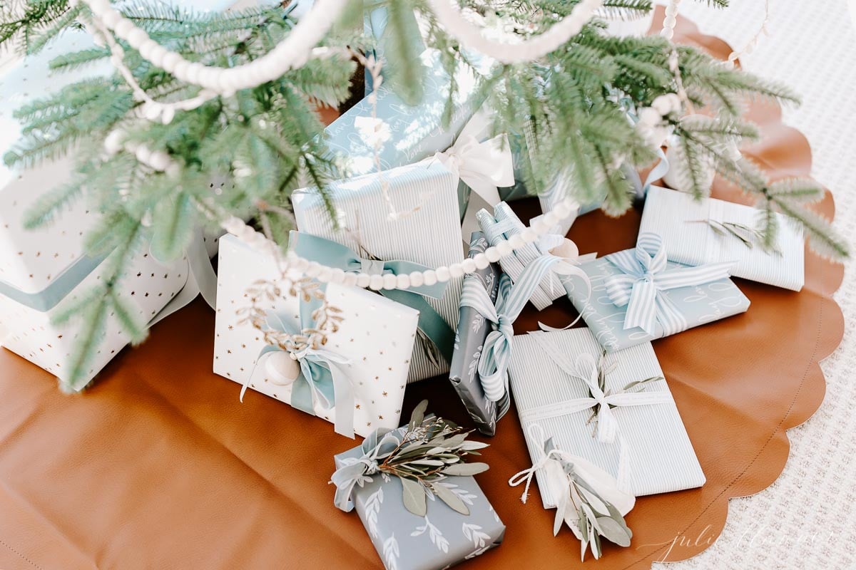 A blue and white Christmas tree adorned with presents.