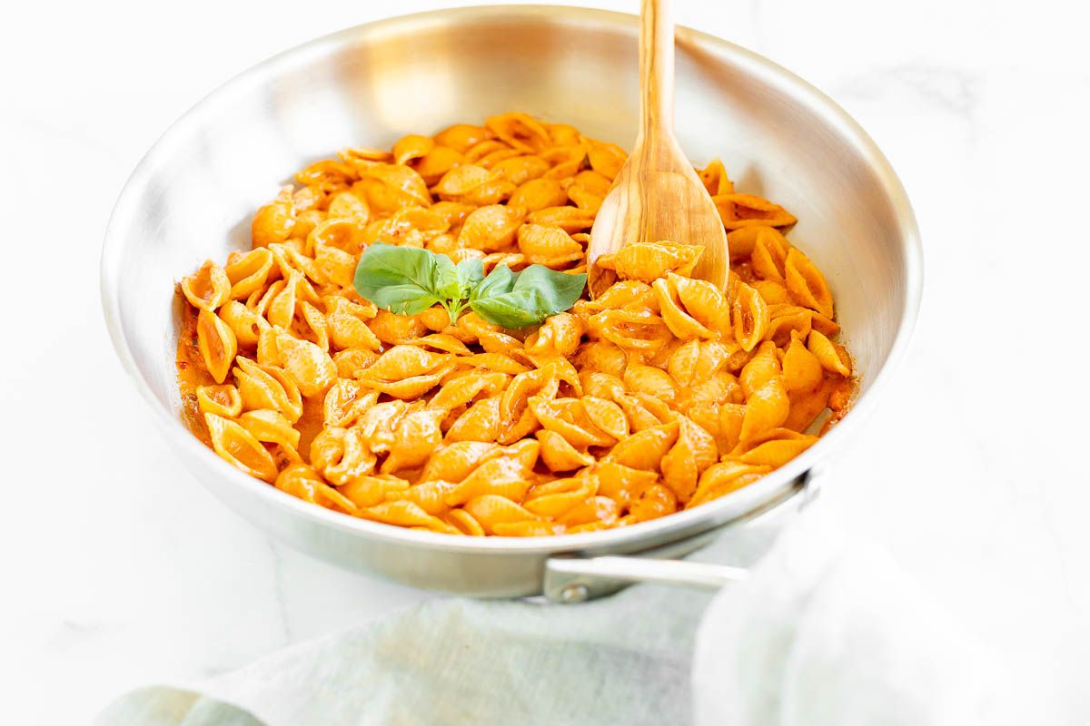 A silver pan full of Gigi Hadid pasta, a spicy vodka shell pasta recipe.