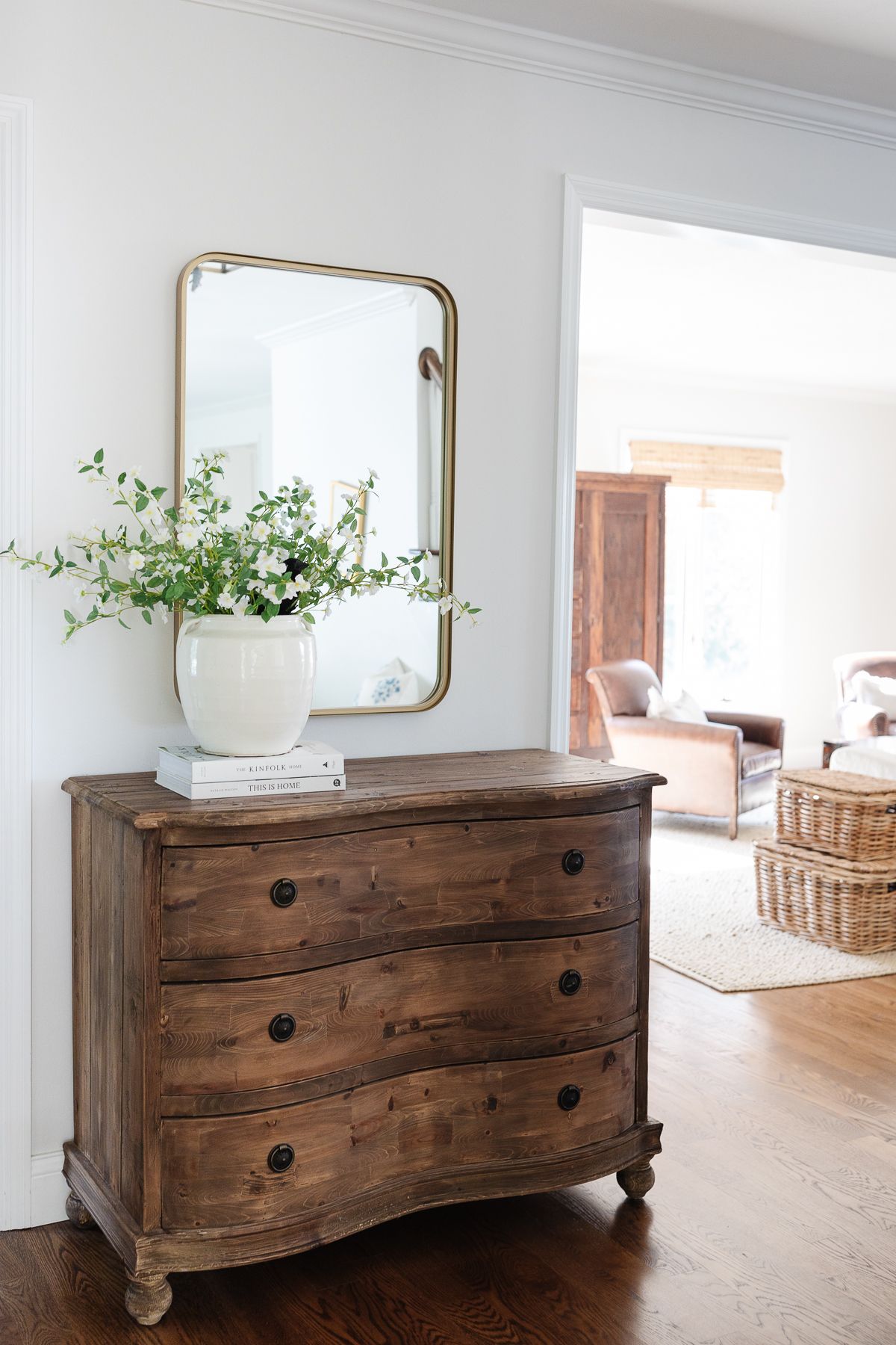 An entryway with a wooden console and Halloween decorating 