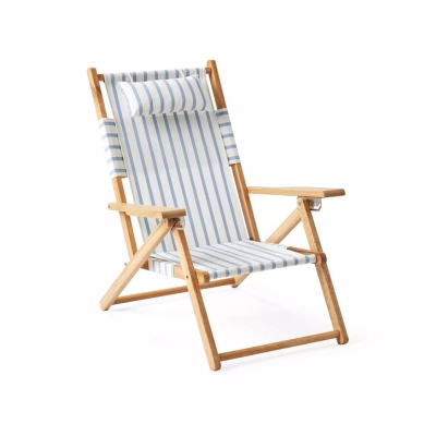 a blue and white striped folding beach chair