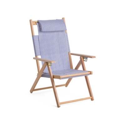 a blue and white striped folding beach chair