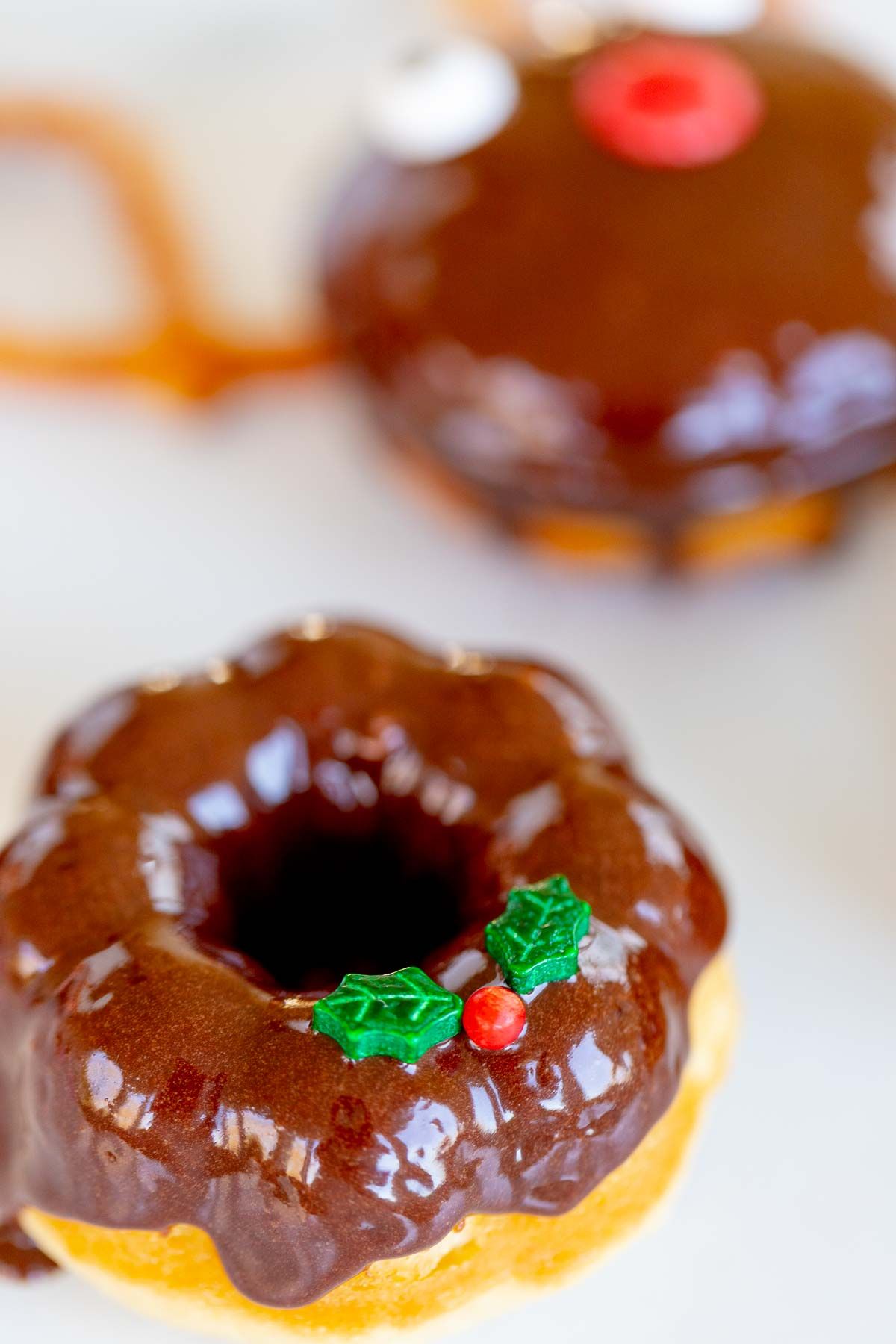 A homemade chocolate Christmas donut on a marble surface.