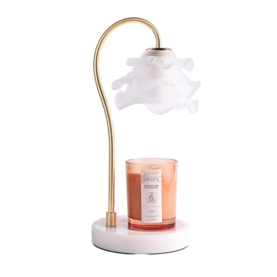 A unique gift idea, this candle lamp adorns a delicate flower, adding elegance to any space.