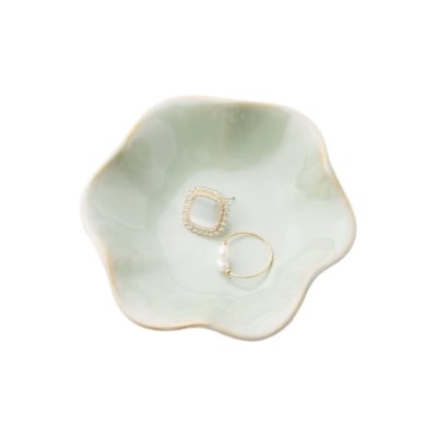 Gift ideas: A unique green bowl, adorned with a delicate ring and featuring a lustrous pearl.