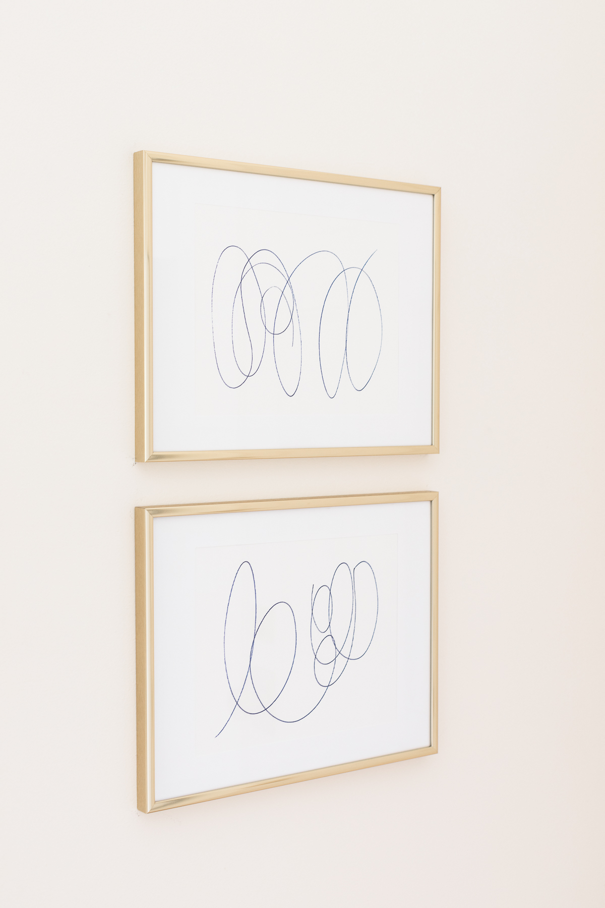 stacked scribble art in gold frames