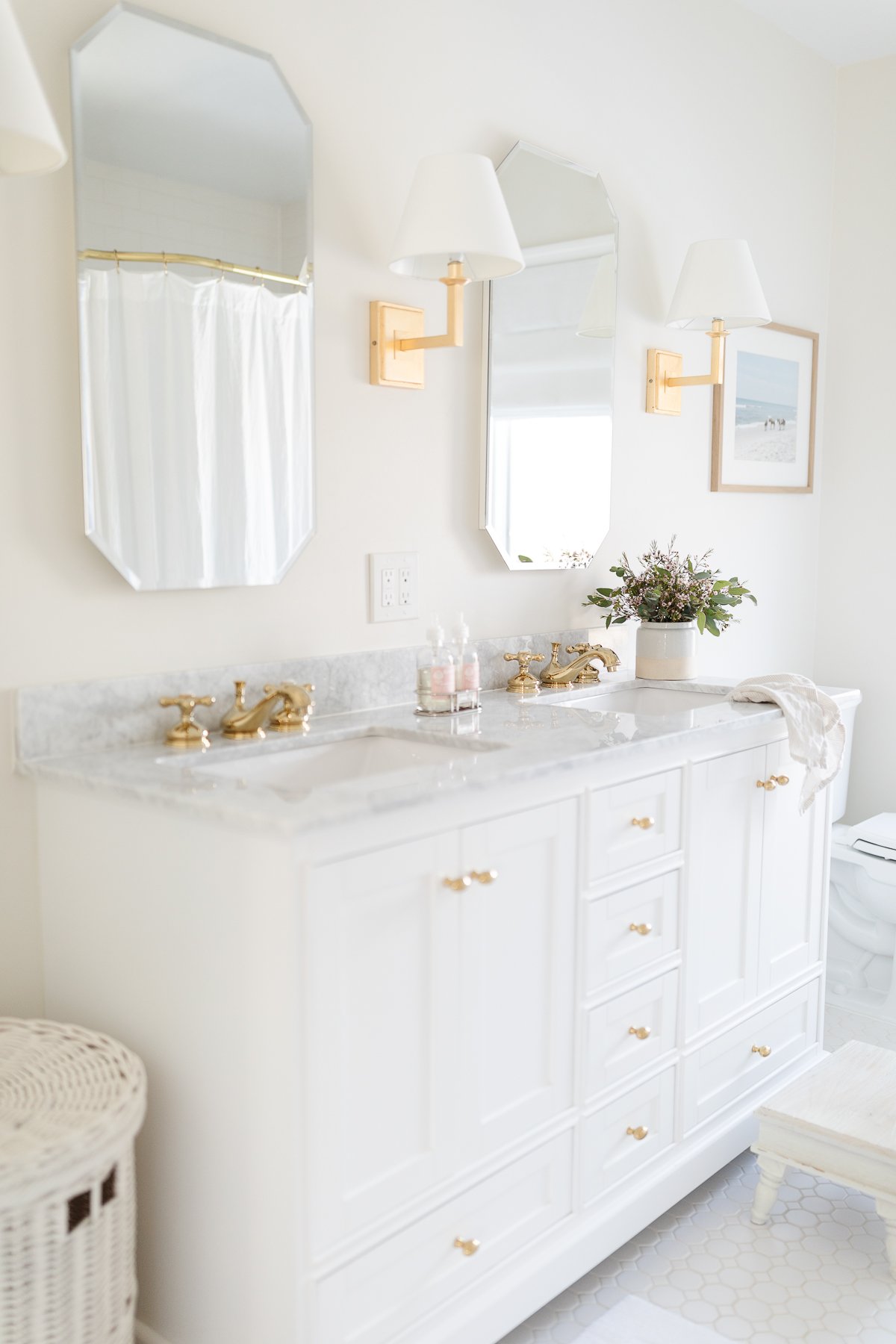 white and cream bathroom with hamper