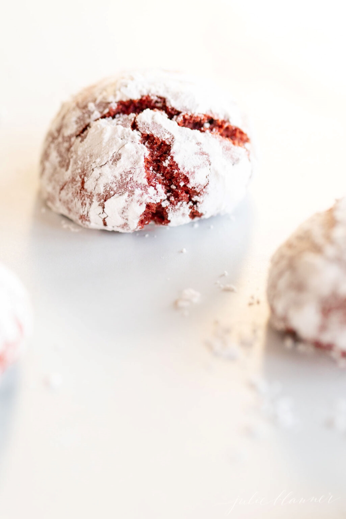 A red velvet Christmas cookie on a white surface.