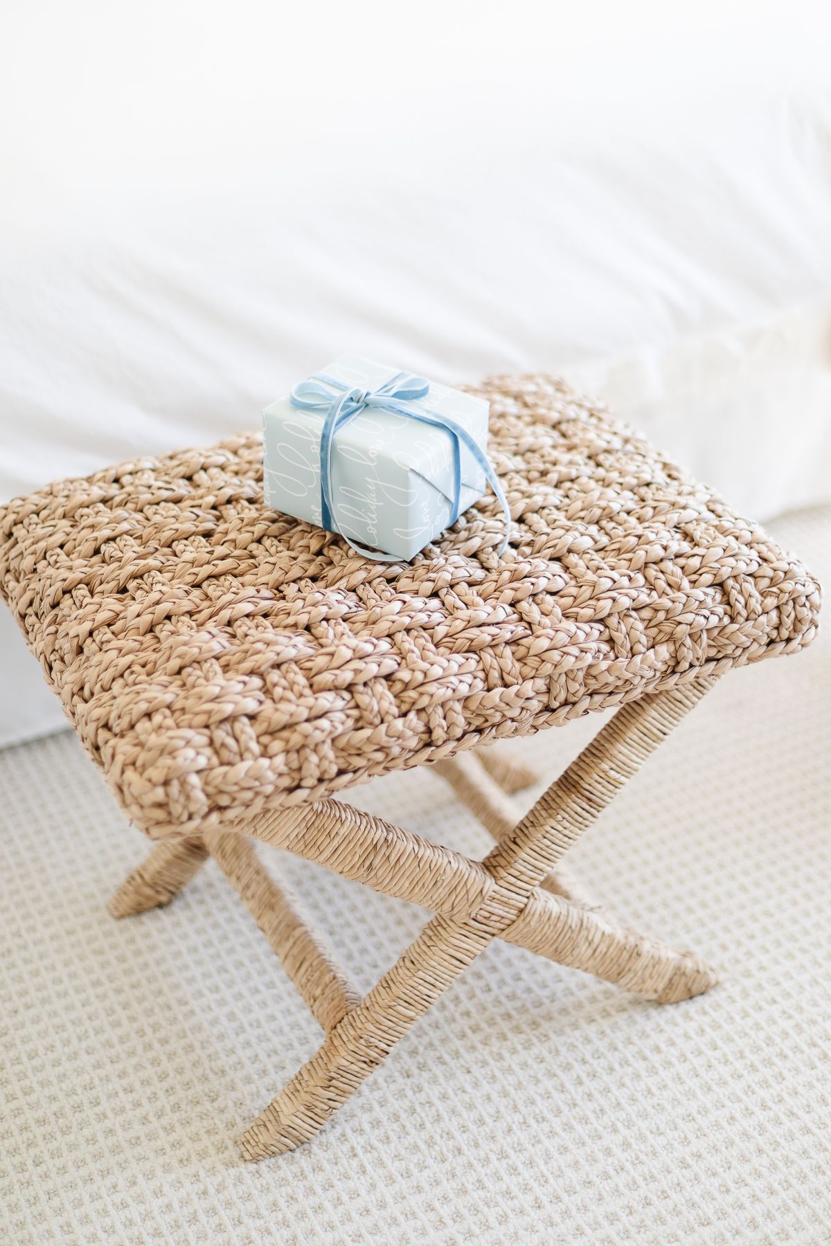A blue and white wrapped package on a stool for a coastal Christmas.