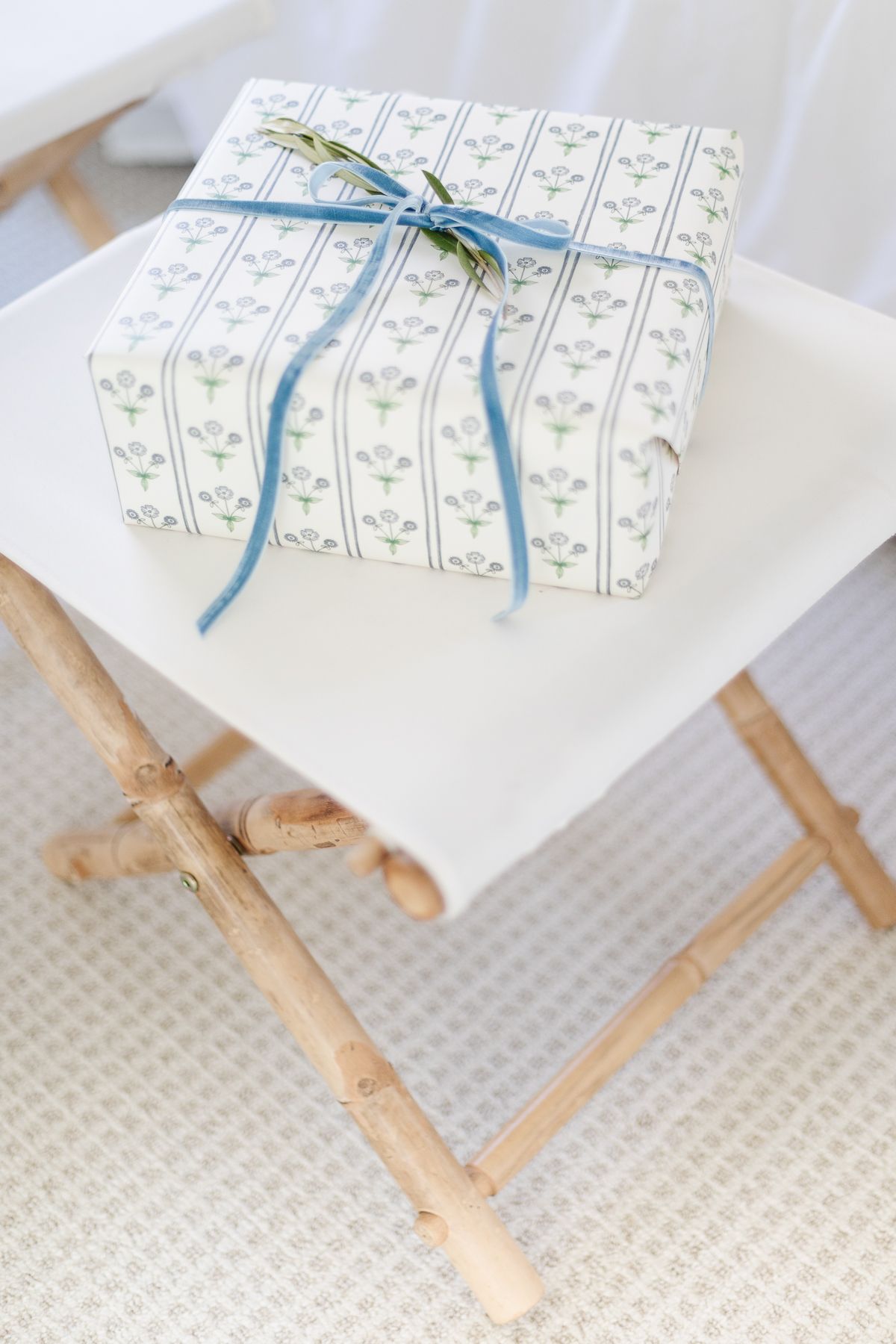 A blue and white wrapped package on a stool for a coastal Christmas.