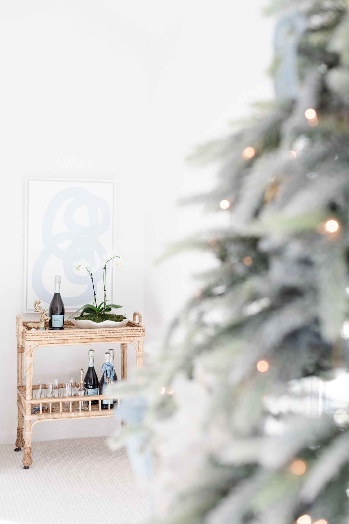 A coastal Christmas tree with a rattan bar in the background.