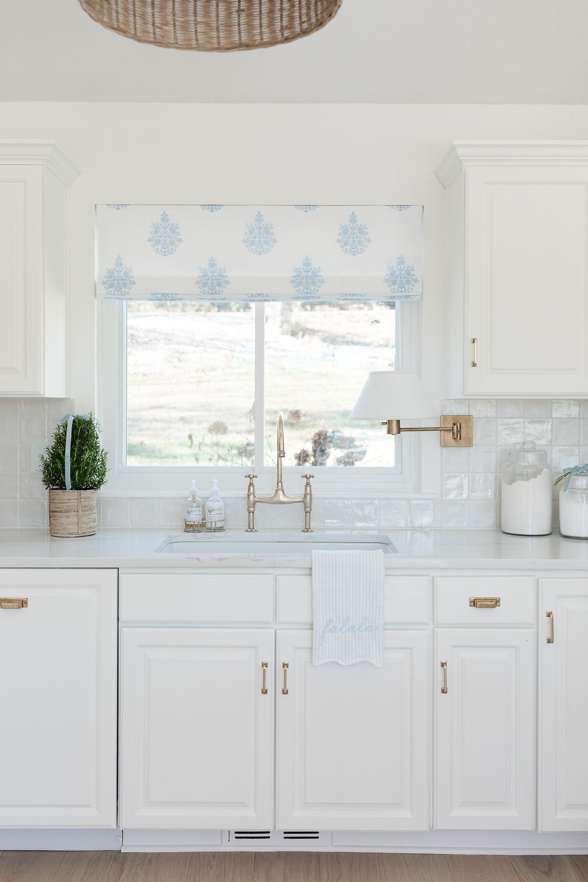 A coastal Christmas kitchen with a rosemary tree by the sink.