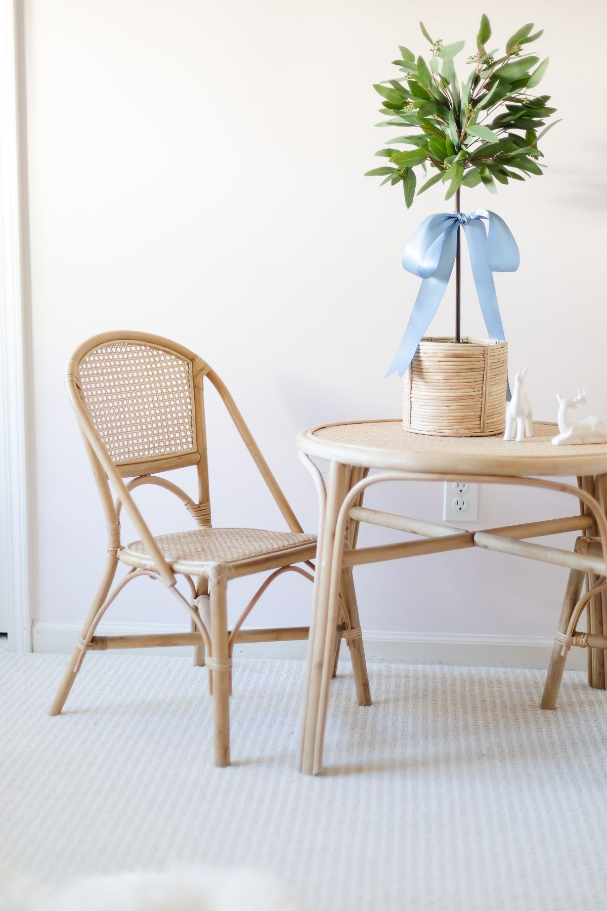 A coastal Christmas kids room, with rattan seating and a eucalyptus topiary