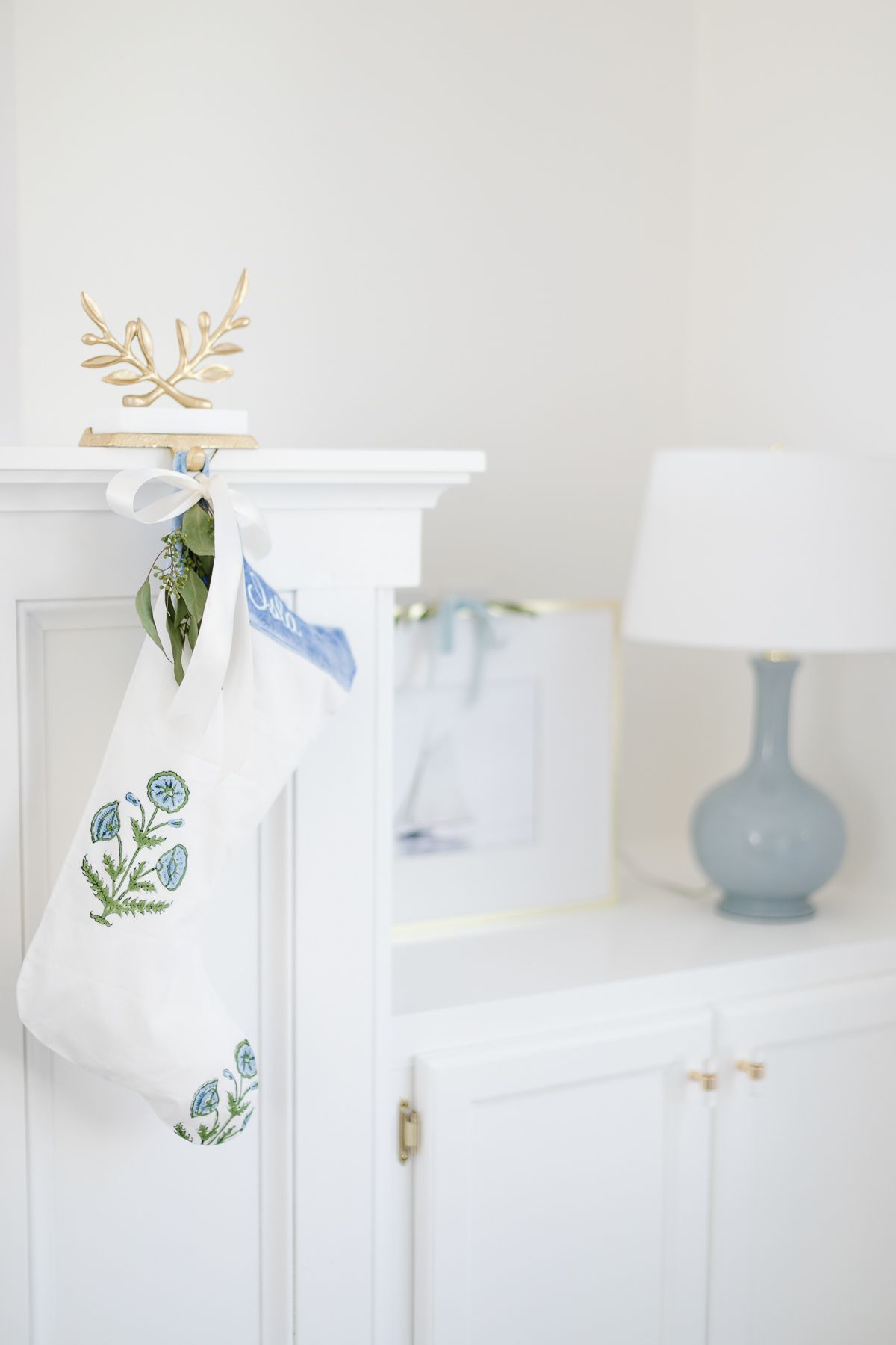 A blue and white stocking in a coastal Christmas living room