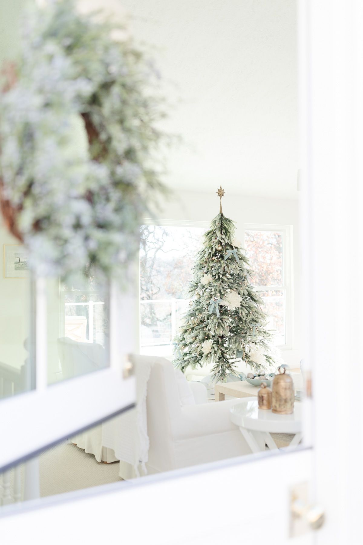 A coastal Christmas tree in a white living room.