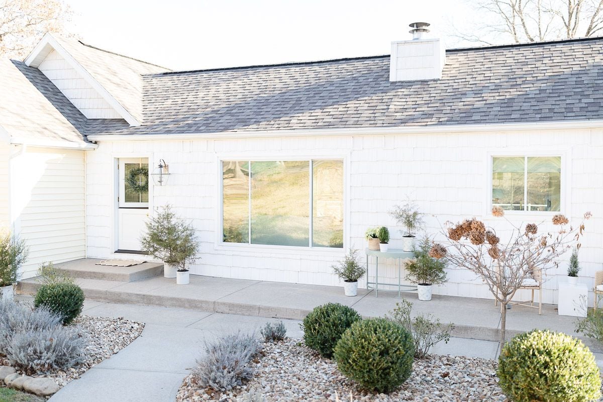 A lake cottage decorated with a garden inspired coastal Christmas porch.