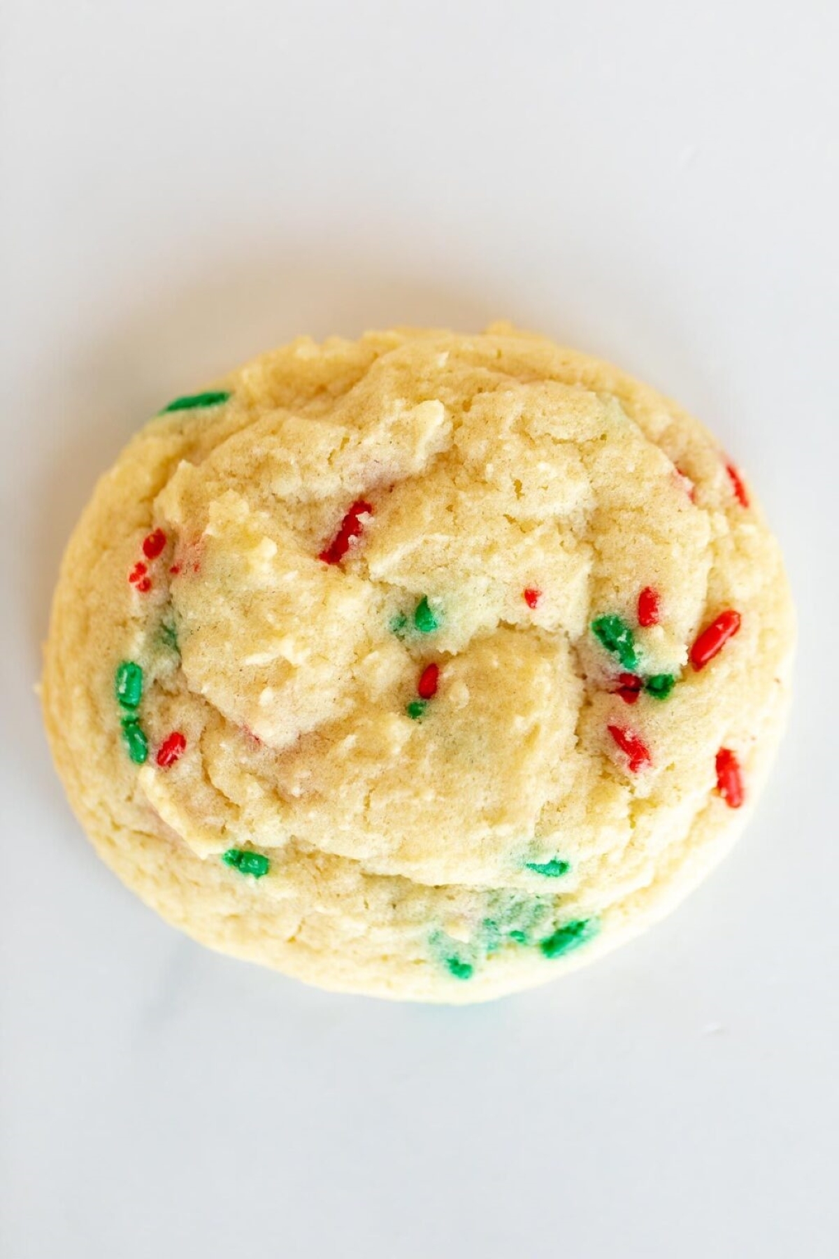 A funfetti Christmas cookie on a white surface.