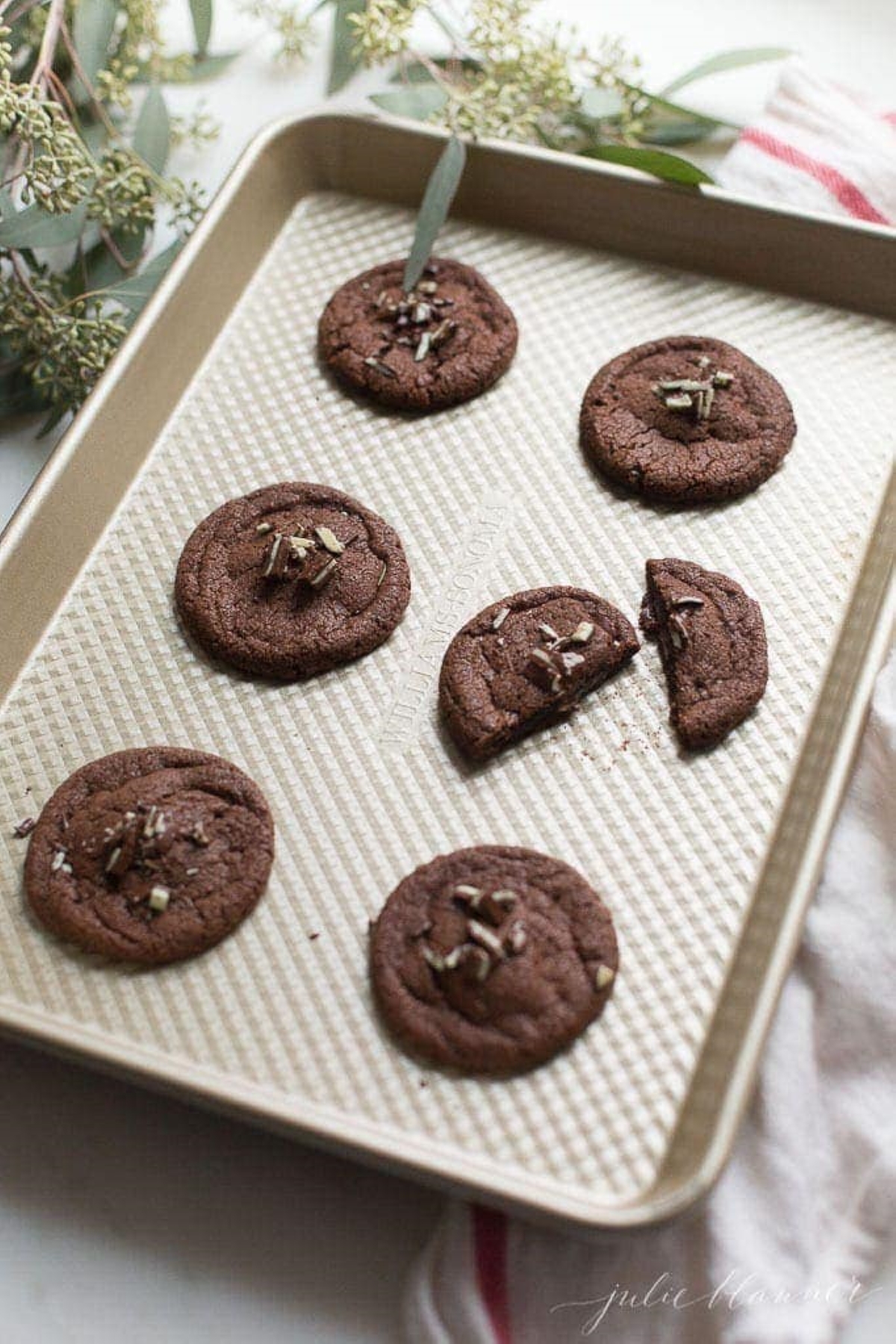 Chocolate mint cookies on a gold baking sheet 