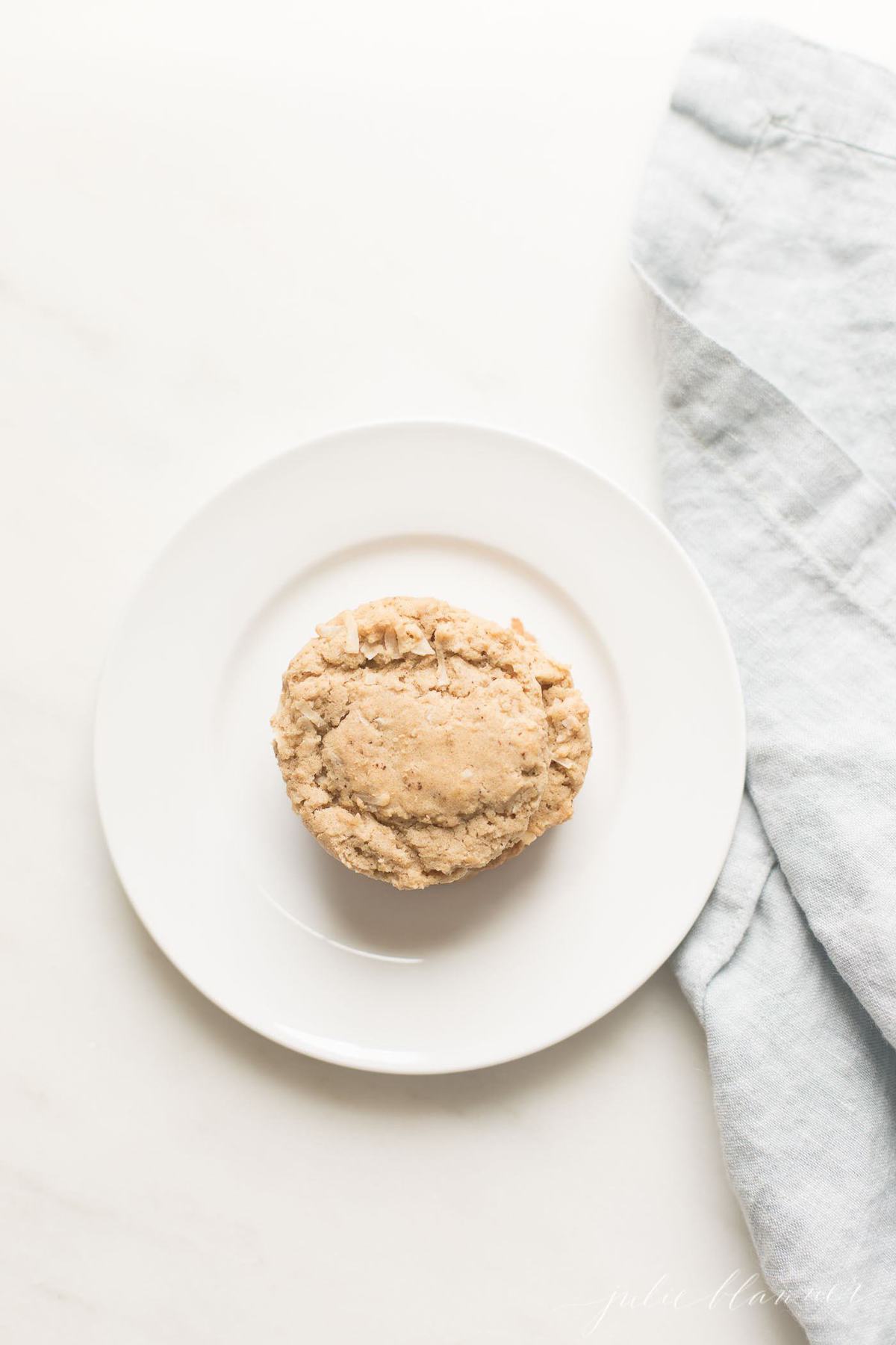 An oatmeal christmas cookie on a white plate.