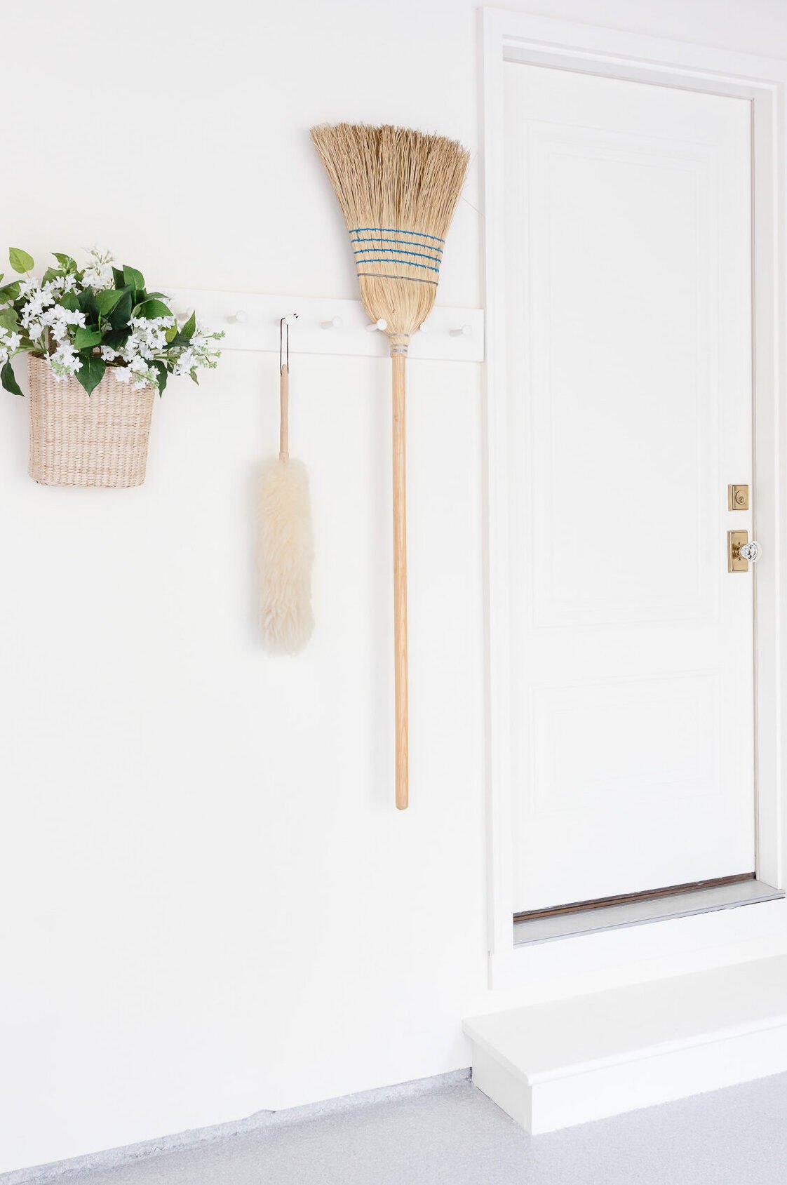 cleaning supplies hanging on peg rail in garage