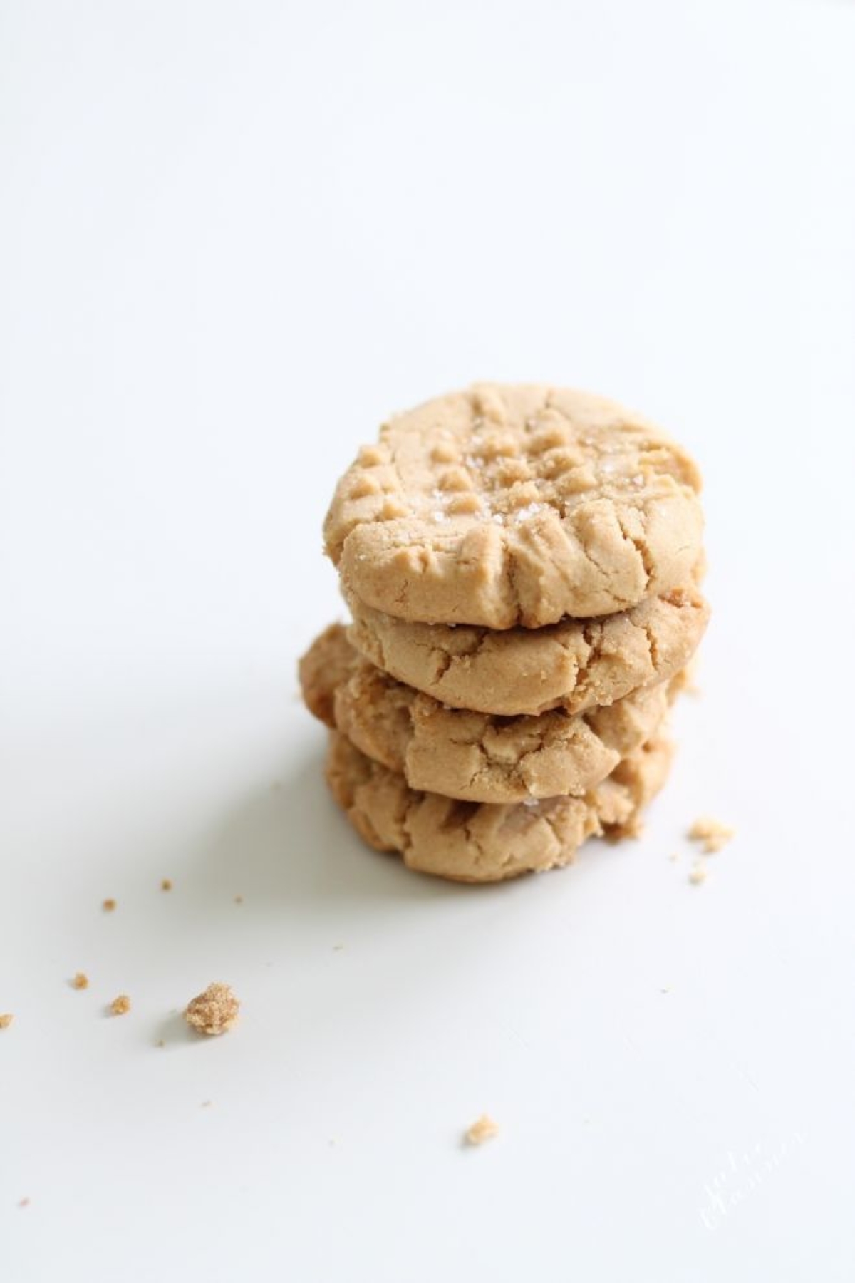 peanut butter cookies stacked on a white countertop