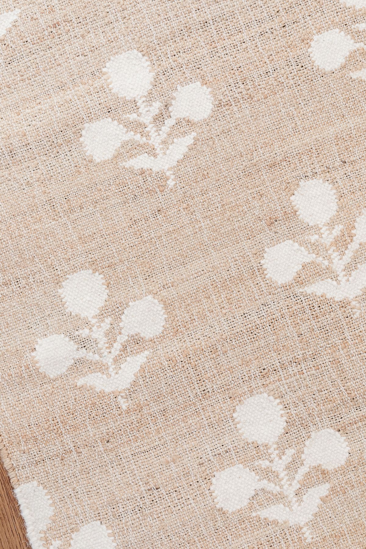 A close up of a white block print rug