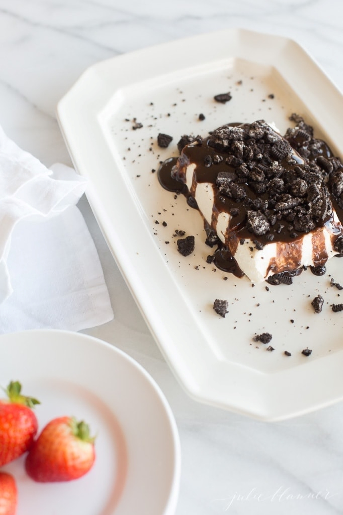 A cookies and cream dessert dip on a white platter