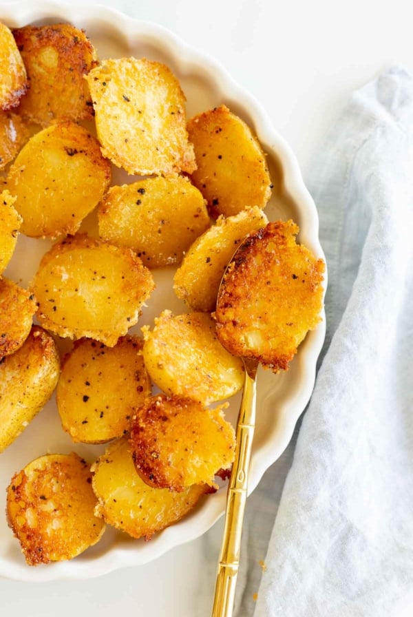 A plate of crispy roasted potatoes seasoned with herbs makes a perfect side dish for chicken.
