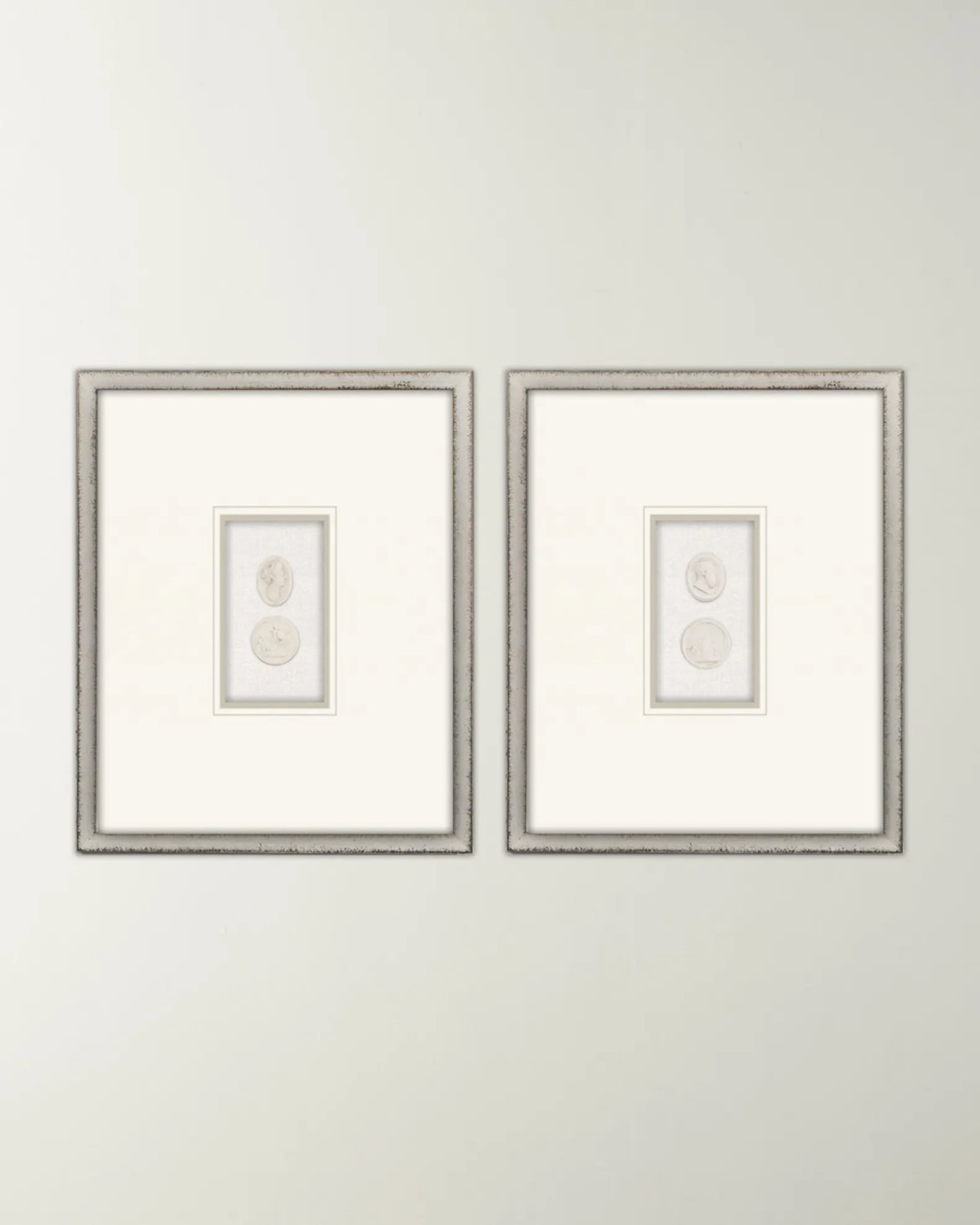 A pair of framed intaglios with a white matting.