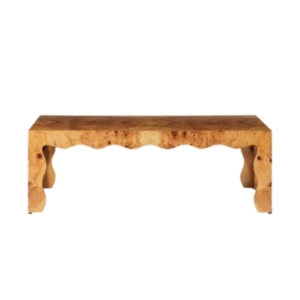 A wooden bench with a scalloped decor top.